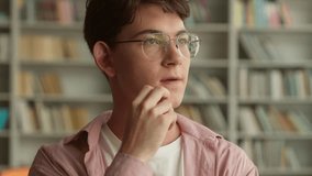 Thinking pensive thoughtful ponder serious think idea puzzled decide plan solution Caucasian teen man teenage male teenager guy boy student schoolboy pupil studying education library school university - Powered by Shutterstock - Get 15% off with code: PIKWIZARD15