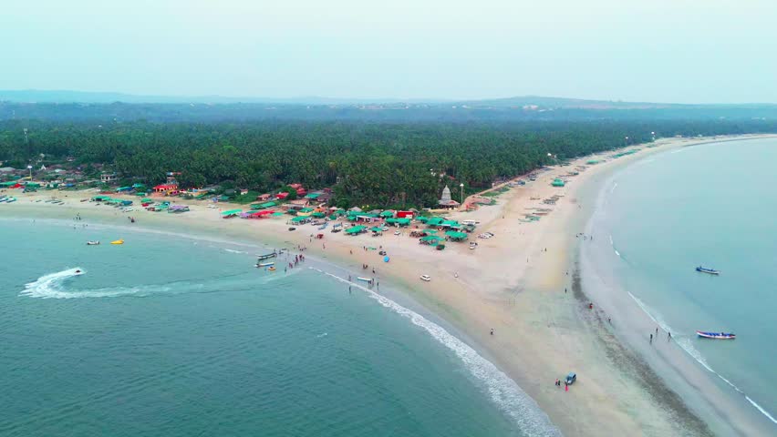 Aerial Shows Colorful Beach Scene with Boats, Drone Shot Palm Frame Coastline Along Green Canopy Shade, Stopped Car Stand Beside Local Food Stall, Tourist Stroll Near Ocean Trail, Enjoy Vacation Time
