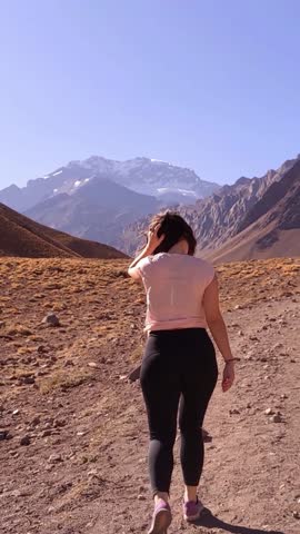 Young Woman Trekking Towards Aconcagua In Mendoza, Argentina - Vertical 4K