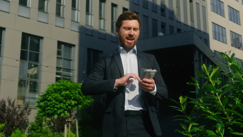 Happy rich carefree wealthy winner worker male employer money rain throwing in city businessman business yelling celebrate winning invest success finance growth salary cash holding banknotes man guy
