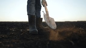 Farmer starts morning work with shovel. Agriculture routine at dawn. Farmer digging soil for planting. Shovel breaking ground on farm. Early morning agriculture work. Farmer prepares field for crops. - Powered by Shutterstock - Get 15% off with code: PIKWIZARD15