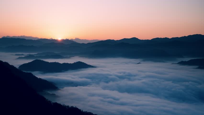 Captured in Xindian, New Taipei City, Taiwan, this image showcases a breathtaking sunrise over mist-covered mountains on a spring morning.