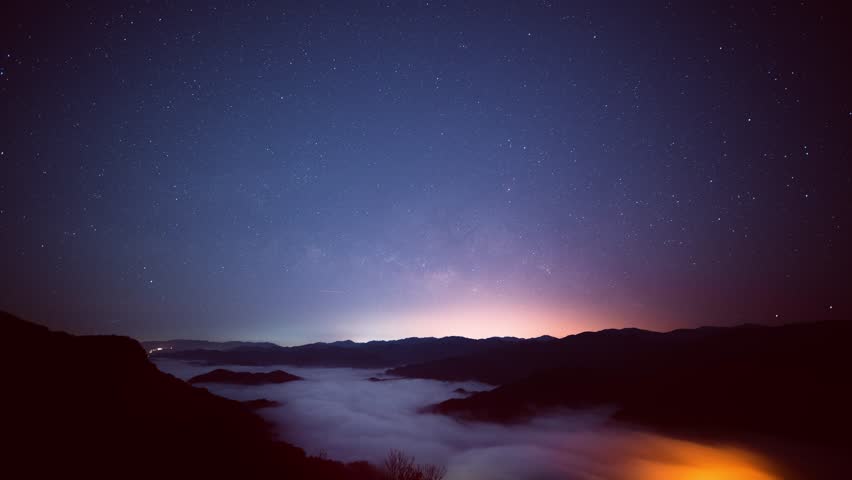 A stunning night view of stars and clouds over mountain ridges in Xindian, Taiwan. Perfect for nature and landscape visuals.
