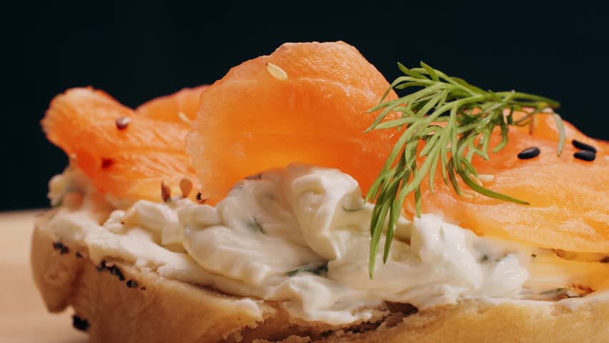 Bagel sandwich brunch, lunch plate of a bagel with smoked salmon and cream cheese and ham, close up morning cafe menu.