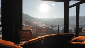Sunlit mountain view from cozy cabin interior, Warm sunlight floods a modern cabin living room with panoramic views - Powered by Shutterstock - Get 15% off with code: PIKWIZARD15
