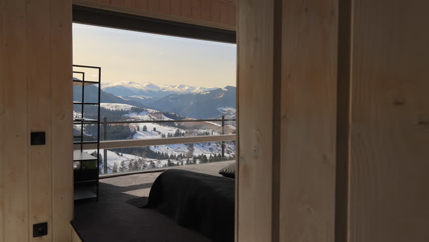 Scenic bedroom with panoramic mountain view, Modern wooden bedroom with large windows overlooking snowy mountains and hills