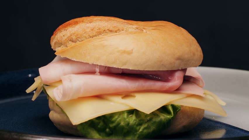 Bagel sandwich brunch, lunch plate of a bagel with smoked salmon and cream cheese and ham, close up morning cafe menu.