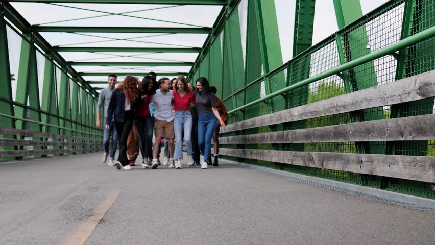 Multiracial group of friends having fun in travel vacations, Happy young people walk on city bridge