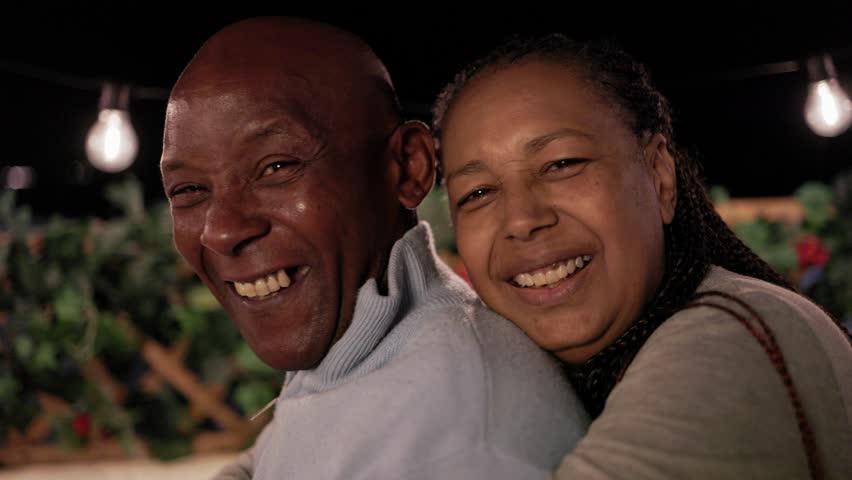 Happy Latin senior couple enjoy moment together outside home terrace , Older people love concept