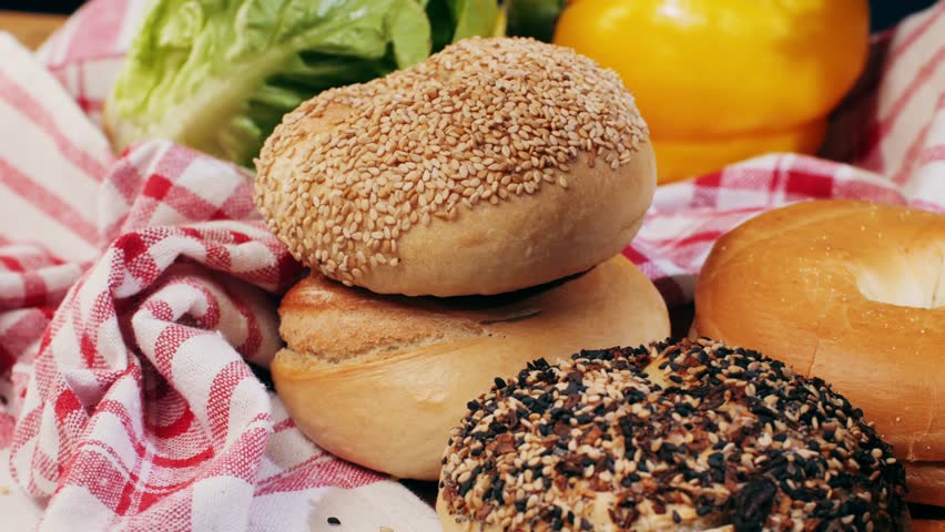 Bagel sandwich brunch, lunch plate of a bagel with smoked salmon and cream cheese and ham, close up morning cafe menu.