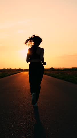 Running sport movement. Strong young woman run in summer park sunset. Training jogging. Jogging outside city, sporty girl doing fitness, jogging on road in sun. Girl runner breathing outdoor in nature