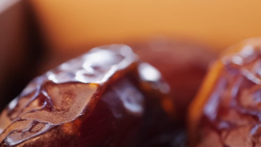 Fresh dates fruits close up on kitchen, close up in supermarket. Eating dried fruits. Vegan, vegetarian food. 