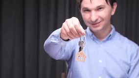 Real estate agent holding keys with house keychain - Powered by Shutterstock - Get 15% off with code: PIKWIZARD15