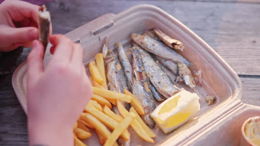 Caucasian Kids Eating Fried Fish and Chips French Fries Fast Food Snack in Styrofoam Box Sold at Seaside Beach Bar