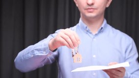Real estate agent holding house keys and contract - Powered by Shutterstock - Get 15% off with code: PIKWIZARD15