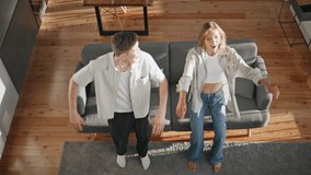 Relaxed couple falling sofa in modern apartment top view. Loving people lying couch having fun together. Young man woman laughing enjoying weekend at home. Happy sweethearts resting cuddling indoors. - Powered by Shutterstock - Get 15% off with code: PIKWIZARD15