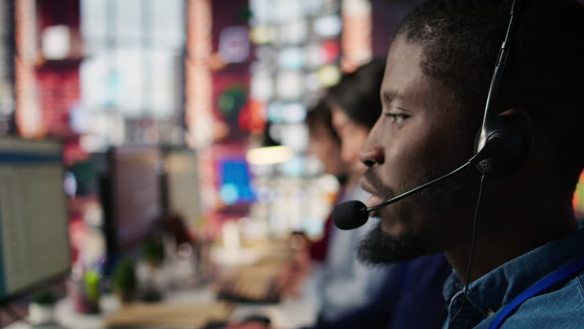 Call center agent using headphones mic to talk with customers, helping regain access to accounts. Customer center worker speaking in microphone, assisting clients needing help, camera B close up