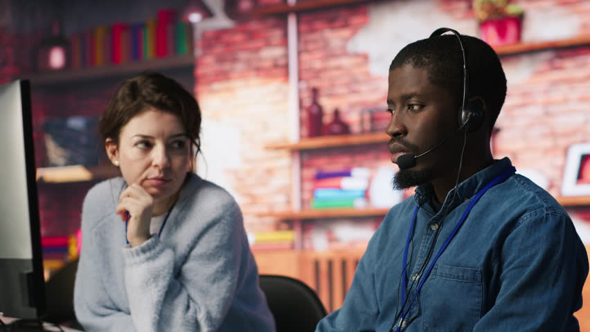 Call center manager supervising agent providing step by step guidance to customers. Customer center supervisor overseeing work done by employee walking clients through technical solutions, camera A - Powered by Shutterstock - Get 15% off with code: PIKWIZARD15