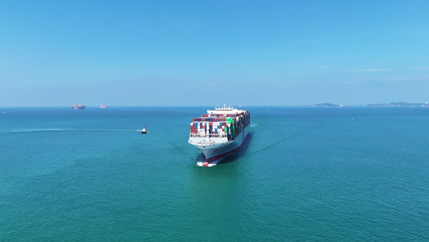 Aerial front view cargo ship carrying container and running for export goods from cargo yard port to custom ocean concept technology transportation. container ship  export import shipping service.
