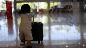 Little boy with suitcase travel in busy airport.  The traveler runs with his suitcase - Powered by Shutterstock - Get 15% off with code: PIKWIZARD15