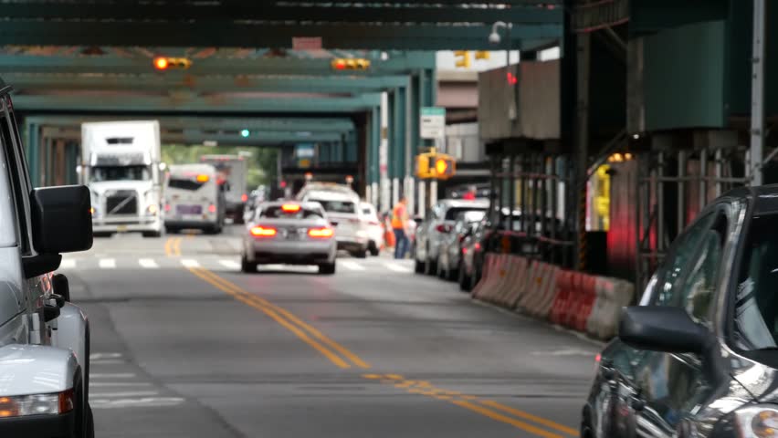 Elevated subway above New York city street. Metropolitan bridge over road, Queens. Long Island overhead metro line, Court Square, United States. Cars under vintage metallic railway track. Urban life.