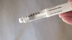 Hand placing the cap on a hormone injection pen for fertility treatment - Powered by Shutterstock - Get 15% off with code: PIKWIZARD15