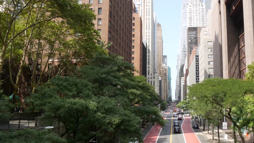 New York Manhattan Midtown architecture. Chrysler building, iconic high-rise skyscraper, 42 street, USA. American urban cityscape, famous NYC tower, United States. Avenue from Tudor City Bridge. Trees
