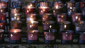 Video of five rows of Offering Candles inside of Mission San Jose church in San Antonio, Texas. Chapel sanctuary with burning candles. Don Despain of Rekindle Photo.