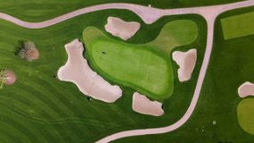Top Down Aerial View of Golf Course Green with Sand Traps and Golfers in Action - Powered by Shutterstock - Get 15% off with code: PIKWIZARD15