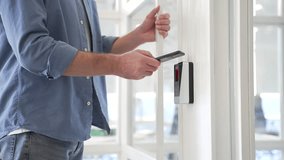 Close up of businessman unlocking door using mobile phone application. Unlocks a modern glass white office. Scanning open smartphone with mock up screen app. Smart electronic locks with keyless access - Powered by Shutterstock - Get 15% off with code: PIKWIZARD15