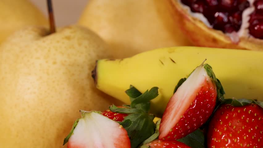 A colorful assortment of sliced tropical fruits including pomegranate, banana, and kiwi, beautifully arranged. - Powered by Shutterstock - Get 15% off with code: PIKWIZARD15