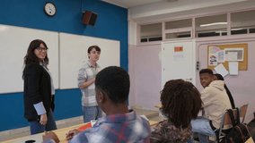 Teacher engaging students in classroom presentation discussion - Powered by Shutterstock - Get 15% off with code: PIKWIZARD15