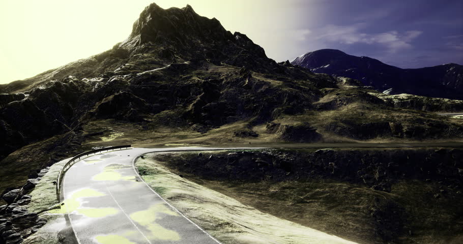 A winding road cuts through rocky mountains as sunlight bathes the landscape, highlighting the dramatic contours and textures of the terrain. The scene evokes a sense of adventure and exploration.