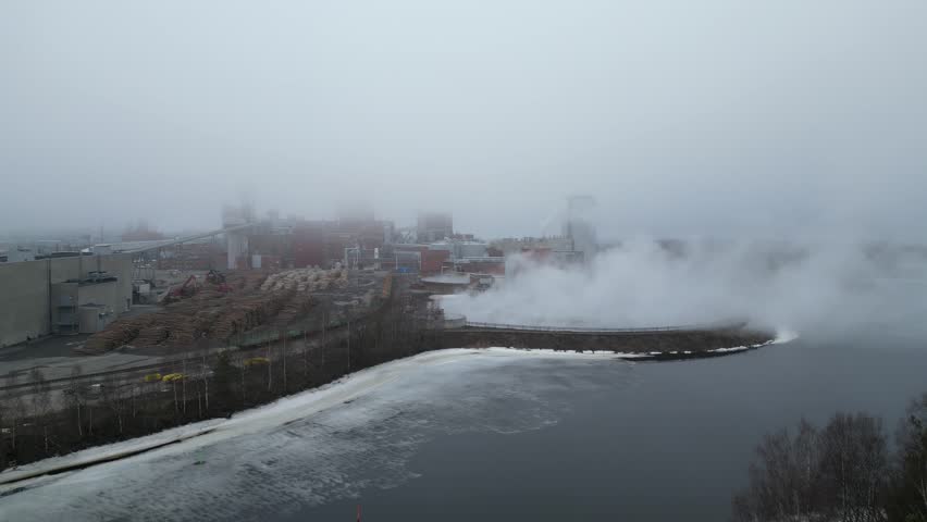 Paper mill factory in fog, Oulu Finland