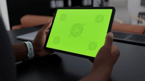 GREEN SCREEN CHROMA KEY A tablet in a person's hand at home, set on a desk, ideal for app or UI mockups. The scene captures a home environment, perfect for productivity or tech apps - Powered by Shutterstock - Get 15% off with code: PIKWIZARD15