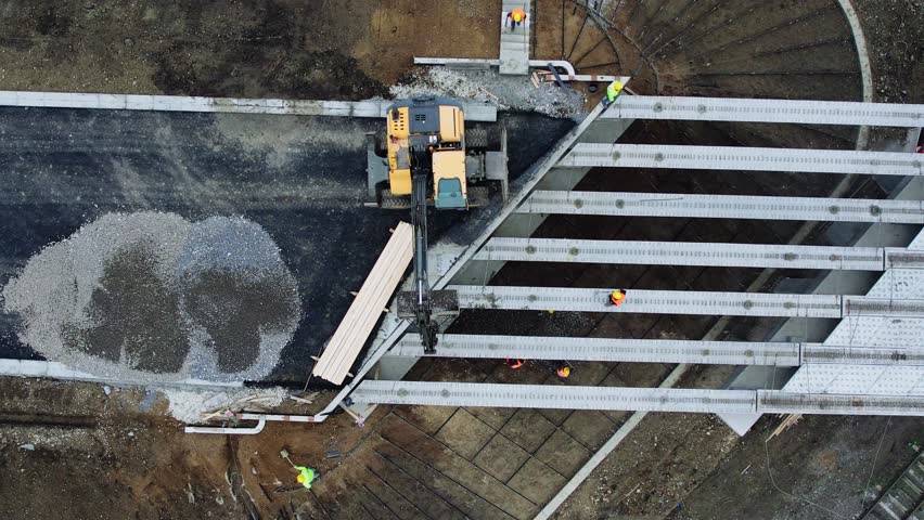 Machines and people working on the bridge construction.Construction of a bridge and roads.