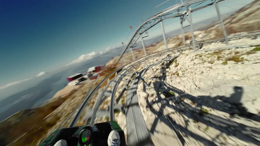 Ride on alpine coaster in Montenegro, first person view in summer sunny day. 