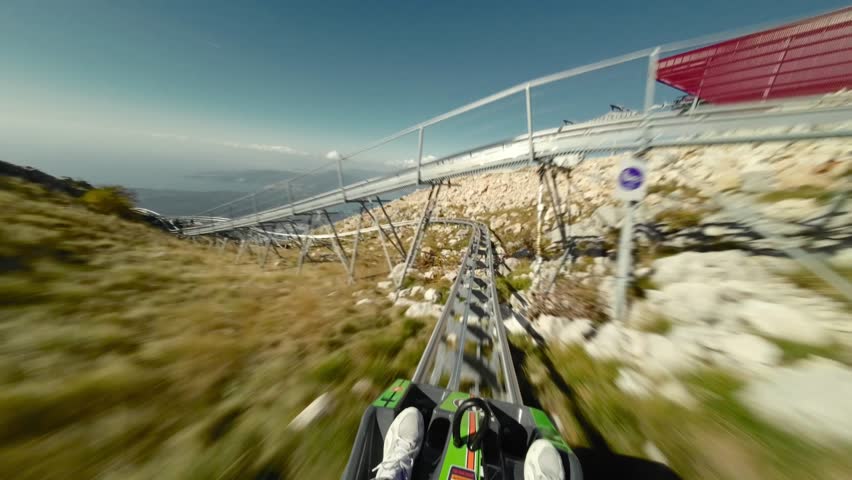Alpine roller coaster in Montenegro, first person view. Lovcen mountain and Bay of Kotor view. Summer, sunny day with a blue sky. 
