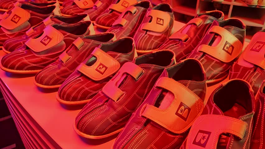 Classic Bowling Shoes Lineup - Red Light Display of Recreational Footwear