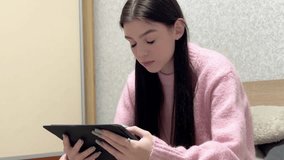 Teenager girl reading or browsing on a tablet - Powered by Shutterstock - Get 15% off with code: PIKWIZARD15