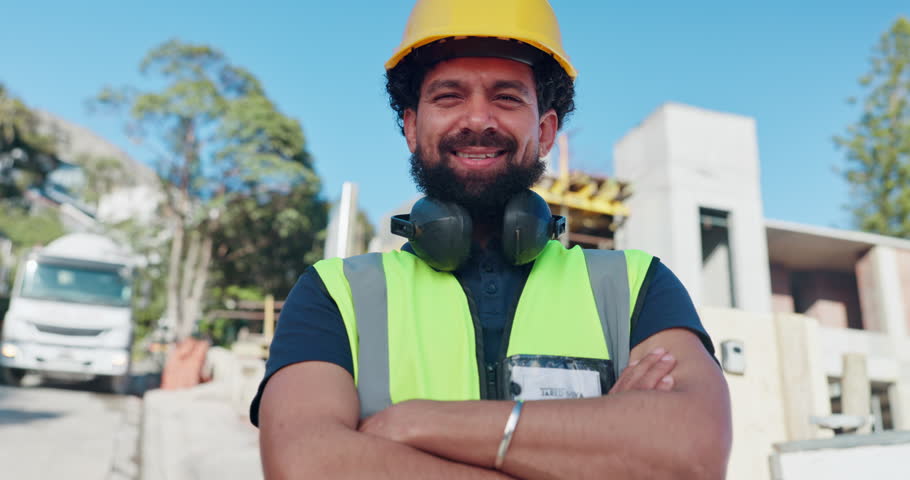 Crossed arms, smile and face of construction worker on site for maintenance, repairs or building. Portrait, infrastructure and happy man industrial civil engineer with project development in Colombia