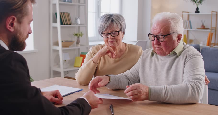 Senior old family couple clients consulting on health, financial insurance with agent lawyer, mature customers meeting bank manager, investment or medical contract, advising, offering expert advice