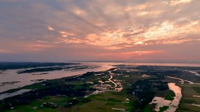 breathtaking sunset over a vast rural landscape, with winding rivers, lush green fields, and scattered villages, creating a serene Cinematic view of nature’s beauty - Powered by Shutterstock - Get 15% off with code: PIKWIZARD15