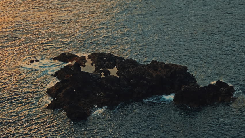 Volcanic rock formation in Atlantic Ocean near Madeira during golden hour