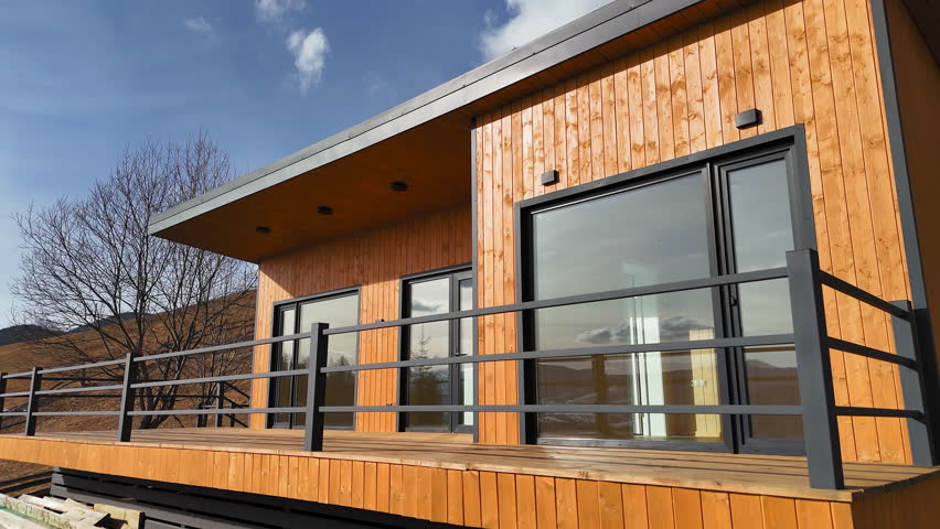 Modern wooden mountain cabin with large windows, Contemporary wood-paneled cabin featuring minimalist architecture,