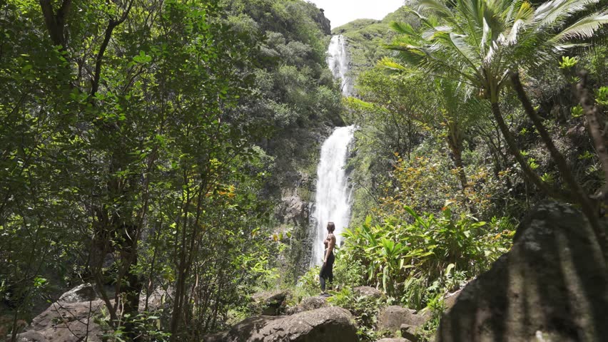 Hiker Women Looks at Hawaii Waterfall Travel