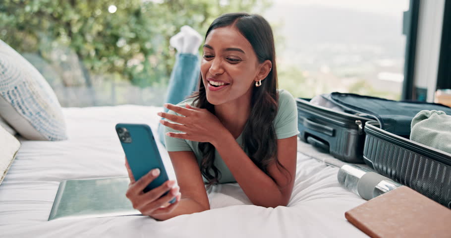Bedroom, suitcase and woman with video call, cellphone and waving with greeting, hello or travel influencer. Relax, home or person with smartphone, digital app and communication with online chatting
