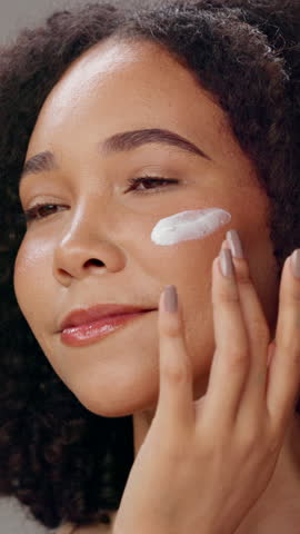 Skincare, face cream and woman in studio with natural, hydration and facial routine. Cosmetic, health and female person with spf, lotion or sunscreen for dermatology treatment for glow complexion.