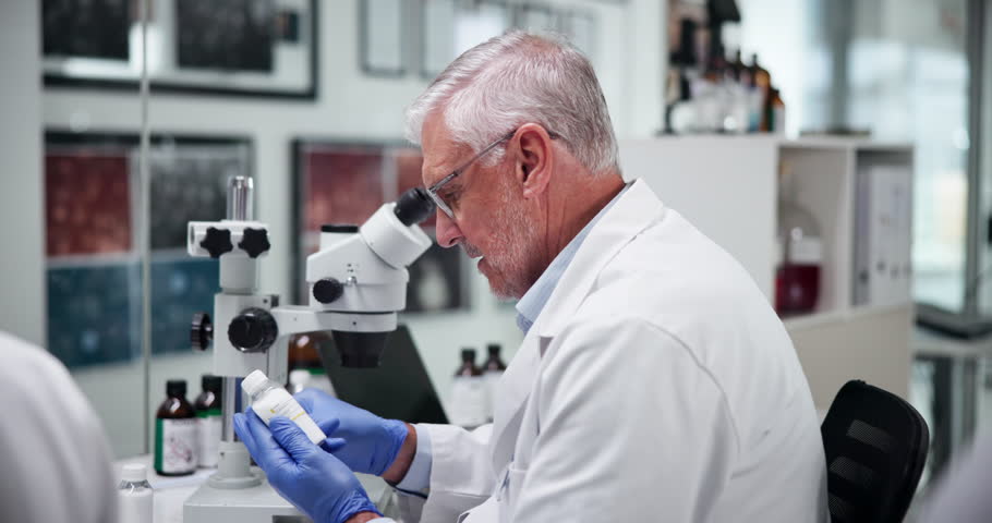 Scientist, man and label on medicine in laboratory for drugs research, production and development. Medical, science and mature doctor with bottle for pharma, healthcare innovation and sticker on cure