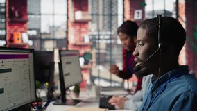 Diverse customer center workers assisting clients with installing software. Multiethnic team of call center agents using remote access tools to connect to customer devices, fixing errors, camera B - Powered by Shutterstock - Get 15% off with code: PIKWIZARD15